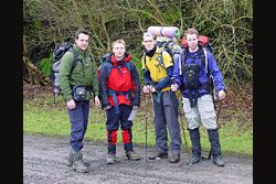 Four boys with hiking gear on