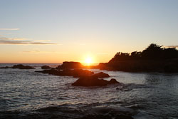 A rocky beach at sunset