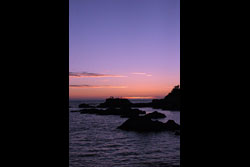 A rocky beach at sunset