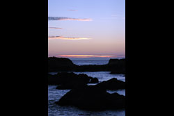 A rocky beach at sunset