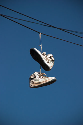 Shoes hanging from electircal wires